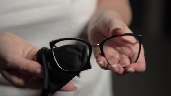 Woman Holds Eyeglasses in Hands