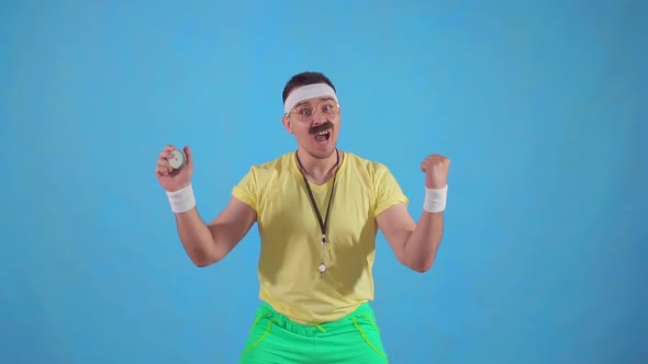 Funny Joyful Male Trainer From the 80's with a Mustache and Glasses with a Stopwatch Slow Mo