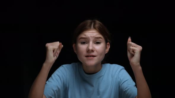 Portrait of a Frightened Young Girl Banging Her Palms on the Glass Calling for Someone Screaming and