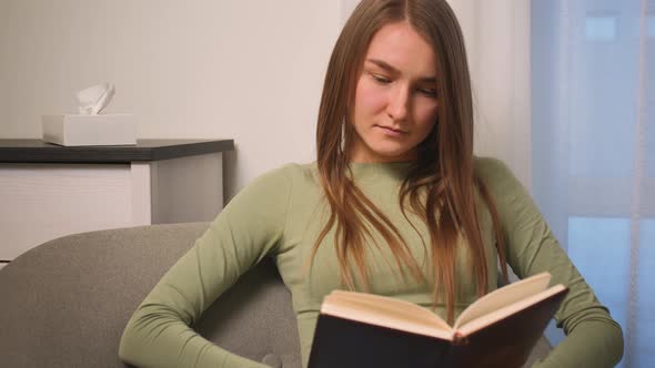 Portrait of Young Woman Reading Book in Cozy Living Room Learning Studying Education Read Books Stay