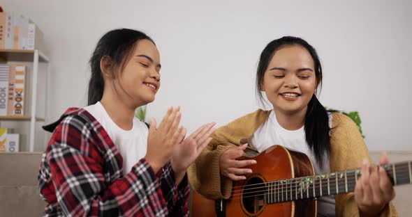 Asian twin girls playing music