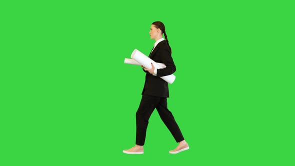 Young Woman in Office Suit Walking with Papers in Hands on a Green Screen Chroma Key