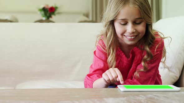 Girl using digital tablet in living room