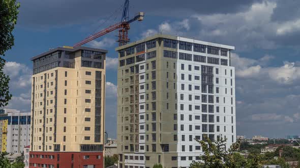 Crane and Building Construction Site Against Blue Sky Aerial Timelapse