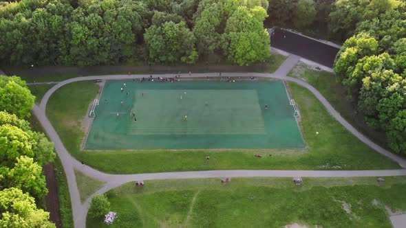 Aerial View of Men Playing Football on a Public City Soccer Field