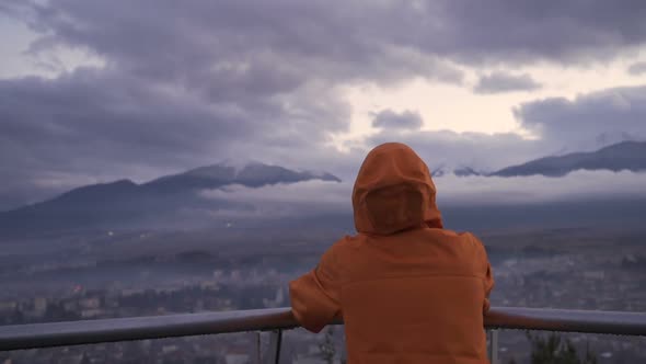 Back View of Man Watching Heavenly View of Razlog City and Misty Mountains