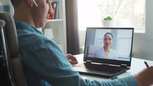 Young male entrepreneur works at home office at the computer.