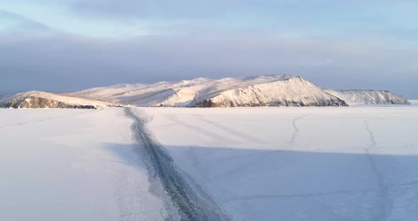 Majestic Snow Winter Ice Landscape. Snow Covered Surface of lake Baikal. Aerial View Flight. 