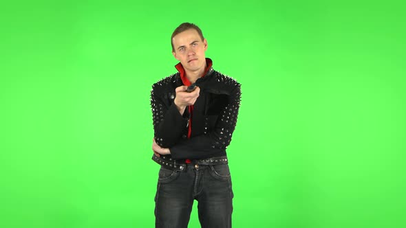 Guy with TV Remote in His Hand, Switching on TV. Green Screen