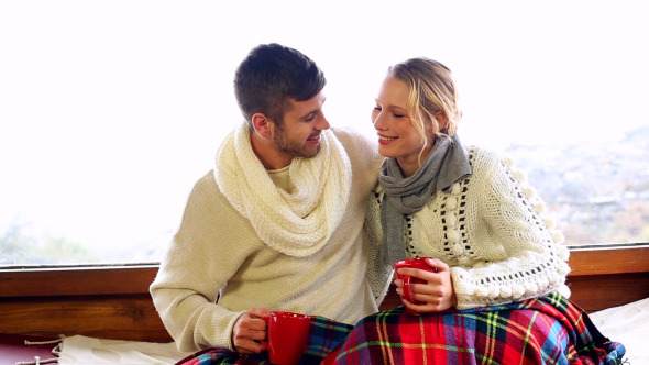 Cute Couple Relaxing Together Under A Blanket 1