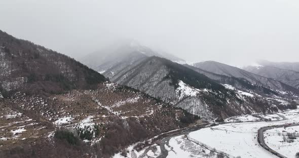 Aerial view of beautiful snowy mountains in Pasanauri, Georgia