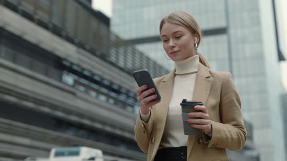 Business Lady with Smartphone and Coffee on Street