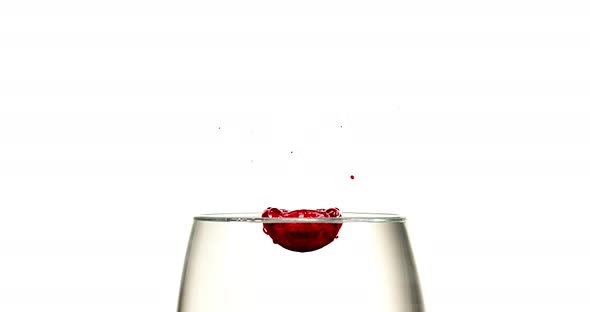 Red Ink falling into Liquid against White Background, Slow motion 4K