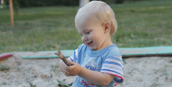 Kid Playing In The Sandbox