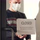 A Handsome Masked Man Walks Up to the Glass Door and Rips Off the 'Closed' Sign - VideoHive Item for Sale