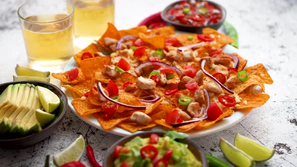 A Plate of Delicious Tortilla Nachos with Melted Cheese Sauce, Grilled Chicken