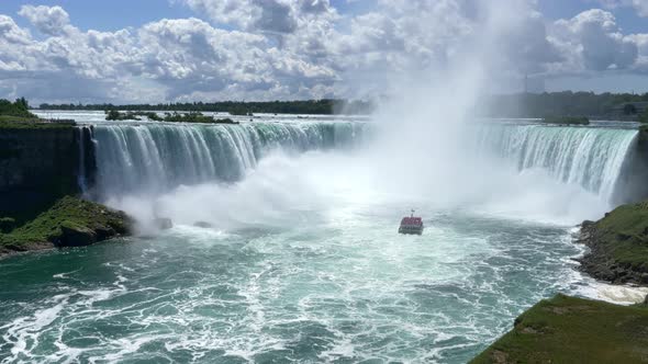 Tourist Boat Maid of the Mist in Niagara Falls Basin, sunny day STATIC