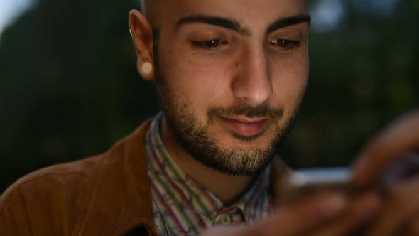 Portrait of young man gay using smart phone