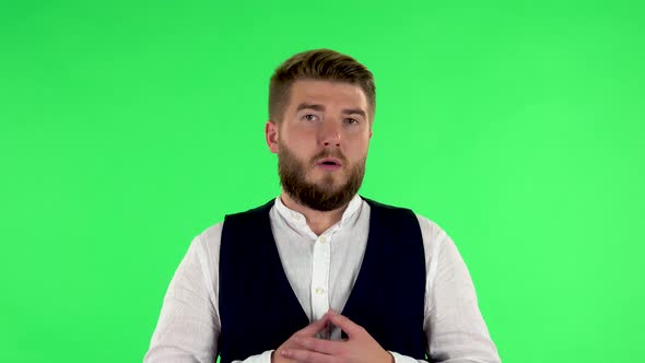 Man Listens To Information Looking at Camera, Is Shocked and Very Upset. Green Screen