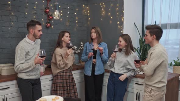 A Group of People at a Festive Event Drinks Wine