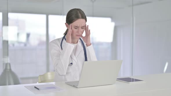 Hardworking Young Female Doctor Having Headache in Office