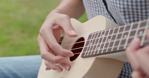 Woman play music on ukulele