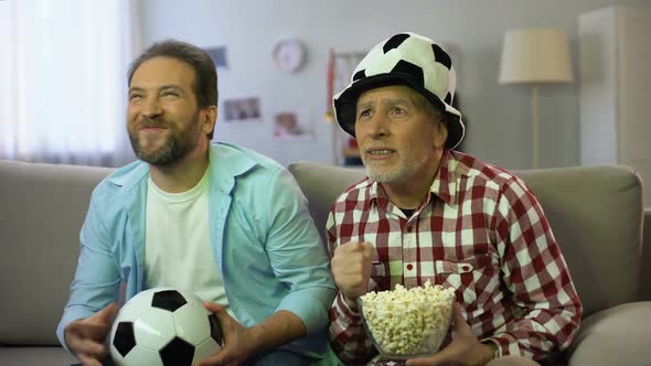 Anxious Adult Males Watching Football Match on Tv, Unhappy About Team Losing