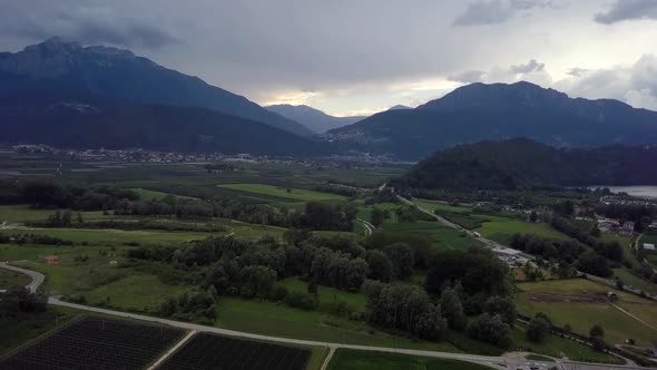 Aerial panoramic view of Levico Terme, Italy, during sunrise with views of the mountains.