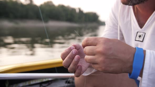 fisherman puts the bait on the hook