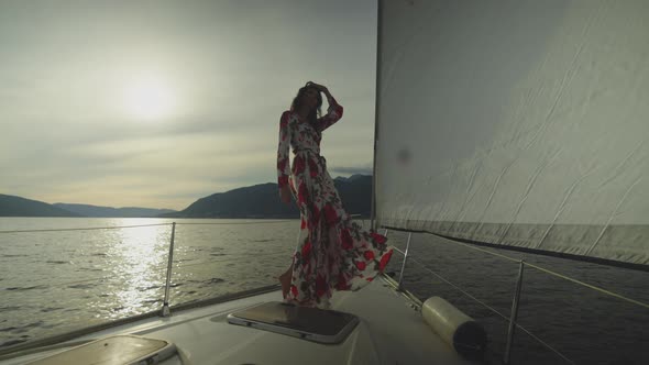 Perfect figure woman posing on sailboat