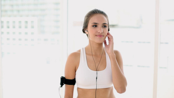 Fit Young Woman Listening To Music Device 2