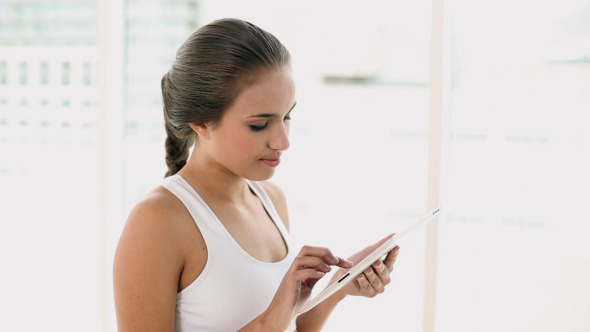 Fit Young Woman Using Her Digital Tablet