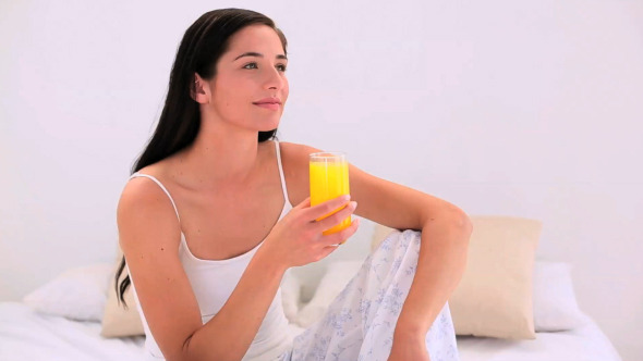 Attractive Brunette Drinking Orange Juice