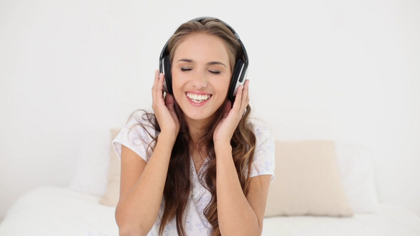 Young Woman Listening To Music And Dancing