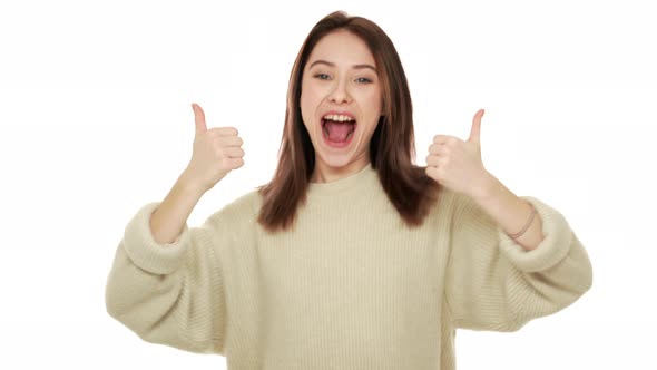 Portrait of Joyful Female 20s Suddenly Emerging on Camera Having Fun Showing Thumbs Up with Happy