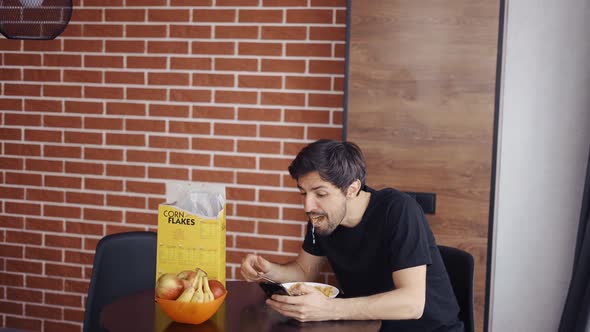 Man Has Breakfast and Use Smart Phone