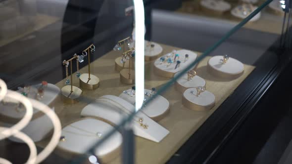 High Angle View Fine Jewellery on Holders on Showcase in Shop