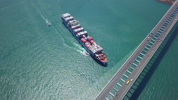 Top view of cargo ship crossing the harbor