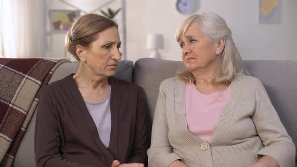 Mature Friends Supporting and Comforting Each Other Sitting on Sofa Pain of Loss