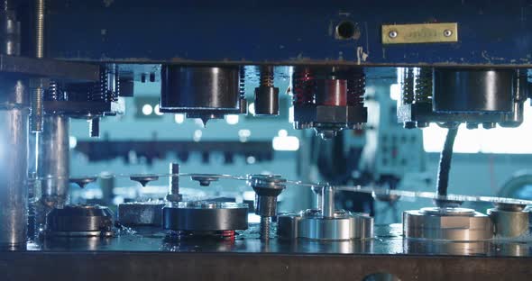 Close up shot of a punch press forming metal parts