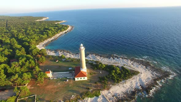 Flying over lighthouse, Croatia at sunset