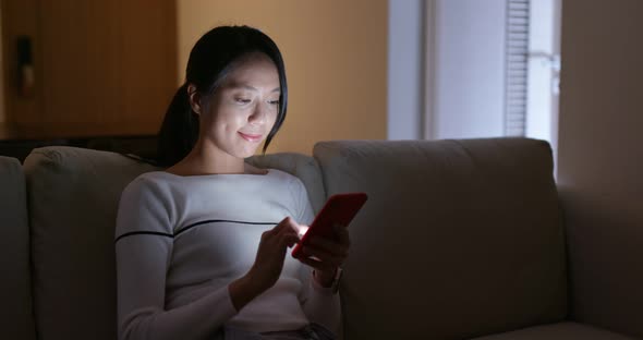 Woman check on cellphone at night