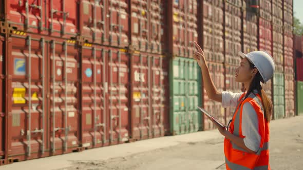 Asian engineer Foreman female worker working checking at Container cargo