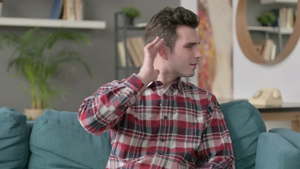 Portrait of Man Listening Carefully While Sitting on Sofa