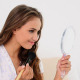 Young Woman Putting Powder On Her Face And Looking - VideoHive Item for Sale