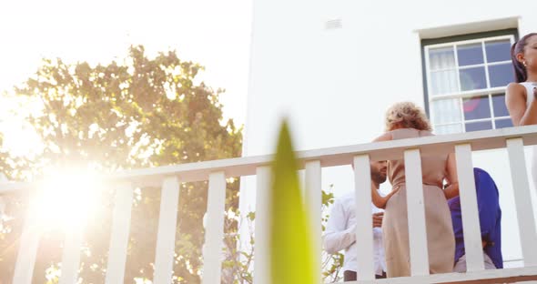 Couple interacting while having champange in balcony