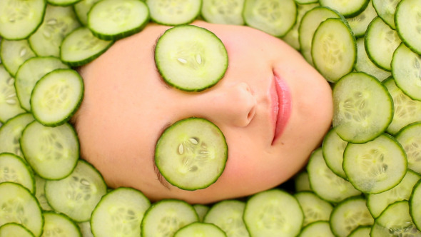 Smiling Womans Face Surrounded By Cucumber Slices 1