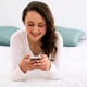 Smiling Woman Lying On Bed Texting On Her Phone 2 - VideoHive Item for Sale