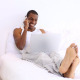 Handsome Man Lying On Bed Phoning And Using Laptop - VideoHive Item for Sale
