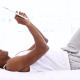 Happy Man Lying On Bed Using His Tablet Pc - VideoHive Item for Sale